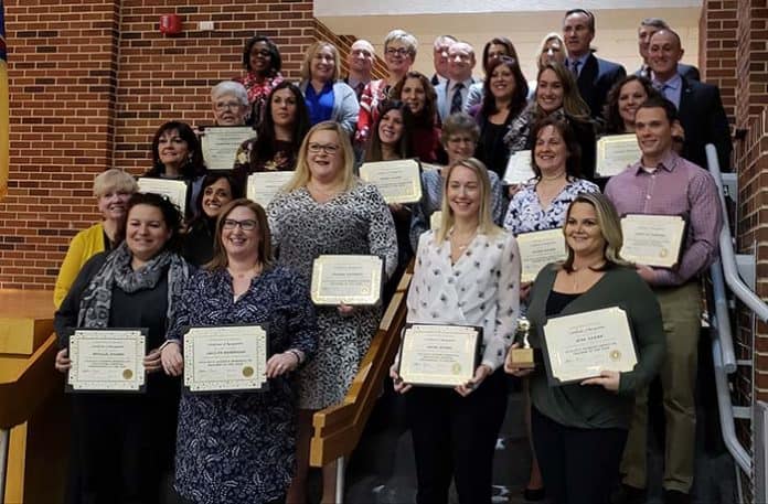 The 2019 Teachers of the Year and Educational Services Professional of the Year gather at the Jackson Memorial High School Fine Arts Auditorium during a Jan. 15 School Board meeting where they received their awards. (Photo by Bob Vosseller)