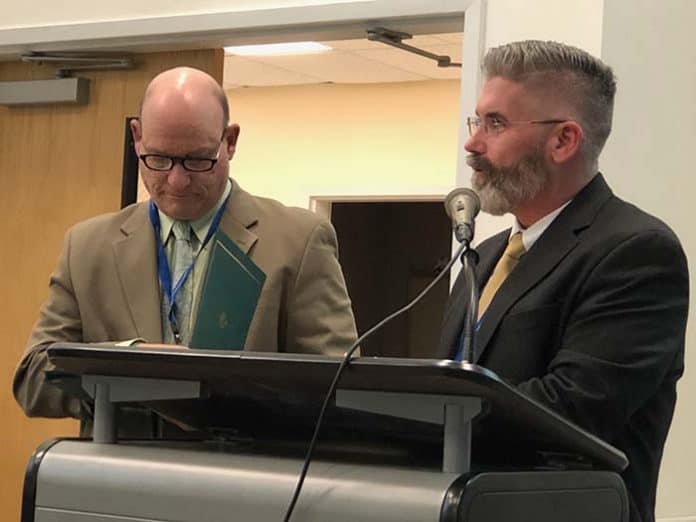 Dennis Filippone, the retiring director of planning, research and evaluation, and Superintendent Gerard Dalton (L to R) handed out certificates to each board member for School Board Recognition Month. (Photo by Judy Smestad-Nunn)