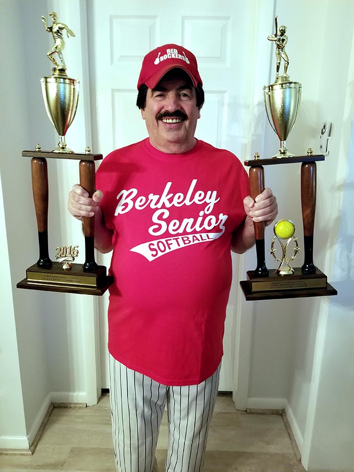 Norm Hoatling displays the trophies won by his summer and fall teams in the Berkeley Senior Softball League. (Photo courtesy of AnneMarie Hotaling)