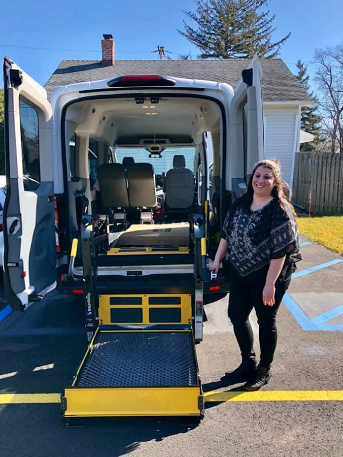 Group home manager Danielle Burdi demonstrates the wheelchair-accessible van used for residents. (Photo by Judy Smestad-Nunn)