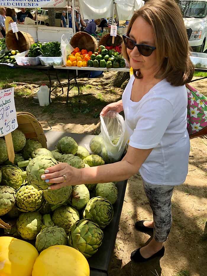 Gina Bonomo of Herbertsville shops the artichokes. (Photo by Judy Smestad-Nunn)