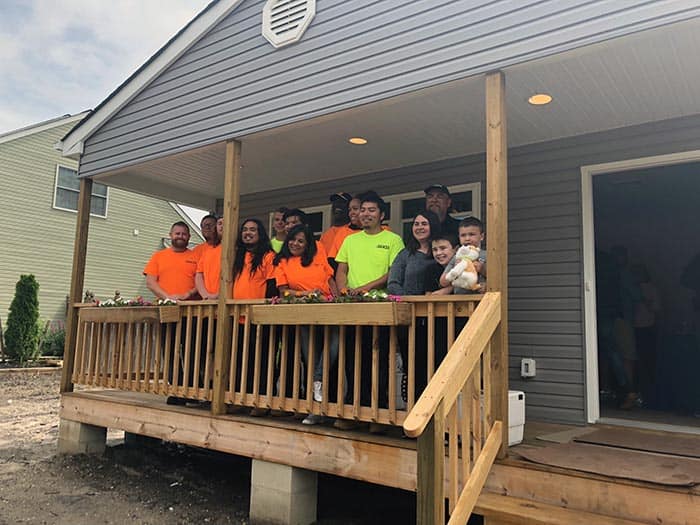 Shaunna Smith and her sons, RJ and Raymond, join members from Habitat for Humanity and OCVTS at the House Dedication Ceremony on June 13. (Photo by Kimberly Bosco)