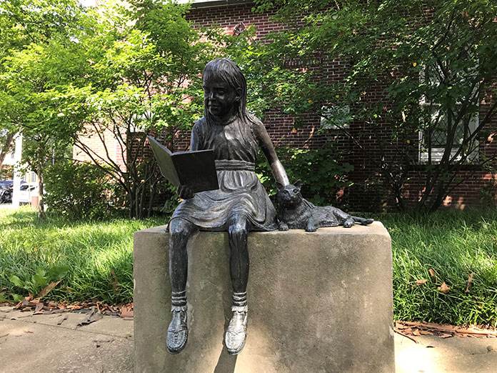 A Statue’s Story: The Girl With The Book